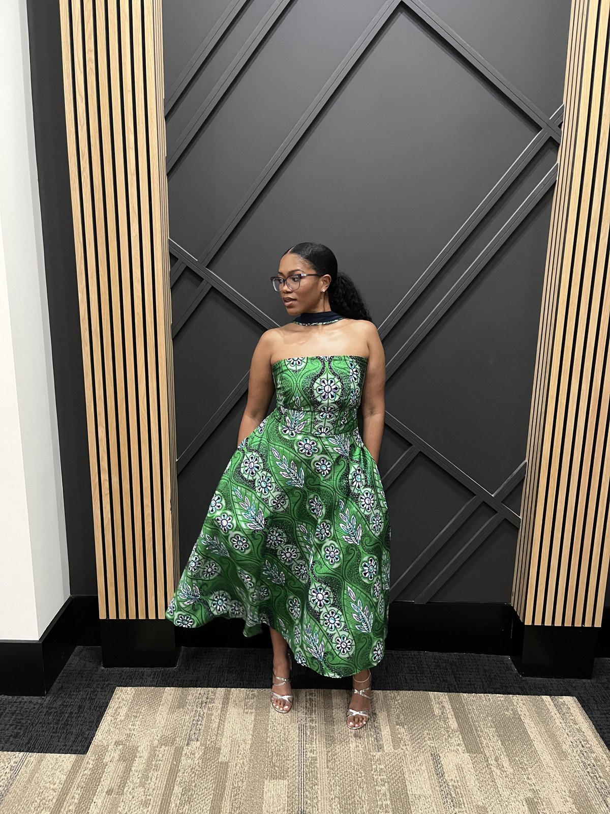 Bria wearing a green patterned dress she made herself